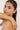 Woman wearing a delicate bracelet on a plain background