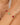Bracelet with red and green beads on a wrist against a neutral background