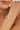 Close-up of a woman's wrist wearing a gold bracelet with pearls.