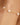 Gold bracelet with pearls on a wrist against a blurred background
