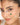 Close-up of a woman's face with delicate bracelet on her face