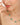 Necklace with green gemstones worn by a woman against a neutral background