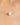 Gold necklace with a pearl and green gemstone on a blurred background