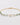 Gold bracelet with green beads and a pearl on a light gray background