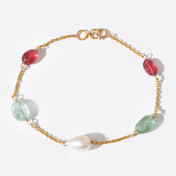 Gold bracelet with colorful beads on a white background