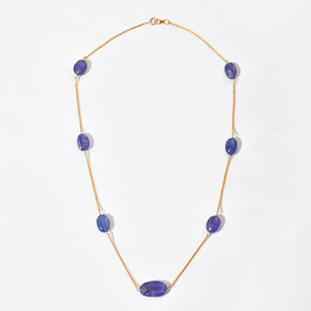 Necklace with purple gemstones on a white background