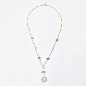 Necklace with pearls and green beads on a white background