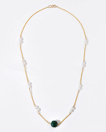 Necklace with green bead and pearls on a white background