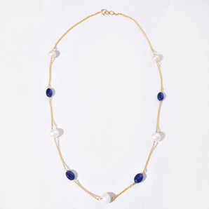 Necklace with blue and white beads on a white background