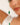 Close-up of a bracelet with green and white beads against a blurred background