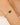 Bracelet with green stone and pearls on a wrist against a neutral background