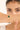 Close-up of a hand wearing a green gemstone bracelet with a blurred background