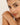 Woman wearing a delicate bracelet on a plain background