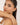 Woman wearing a delicate bracelet on a plain background