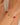 Bracelet with red and green beads on a wrist against a neutral background