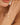 Close-up of a woman's wrist wearing a gold bracelet with pearls.