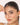 Woman holding a delicate bracelet to her face with a white background