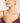 Woman wearing a pearl necklace with a plain background
