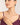 Woman wearing a pearl necklace with a plain background