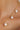 Gold chain necklace with pearl drops on a person's neck