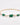 Bracelet with green stones and pearls on a gold chain against a white background