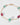 Bracelet with gold chain and green and pink beads on a white background
