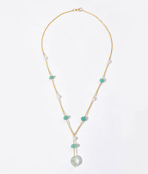 Necklace with pearls and green beads on a white background